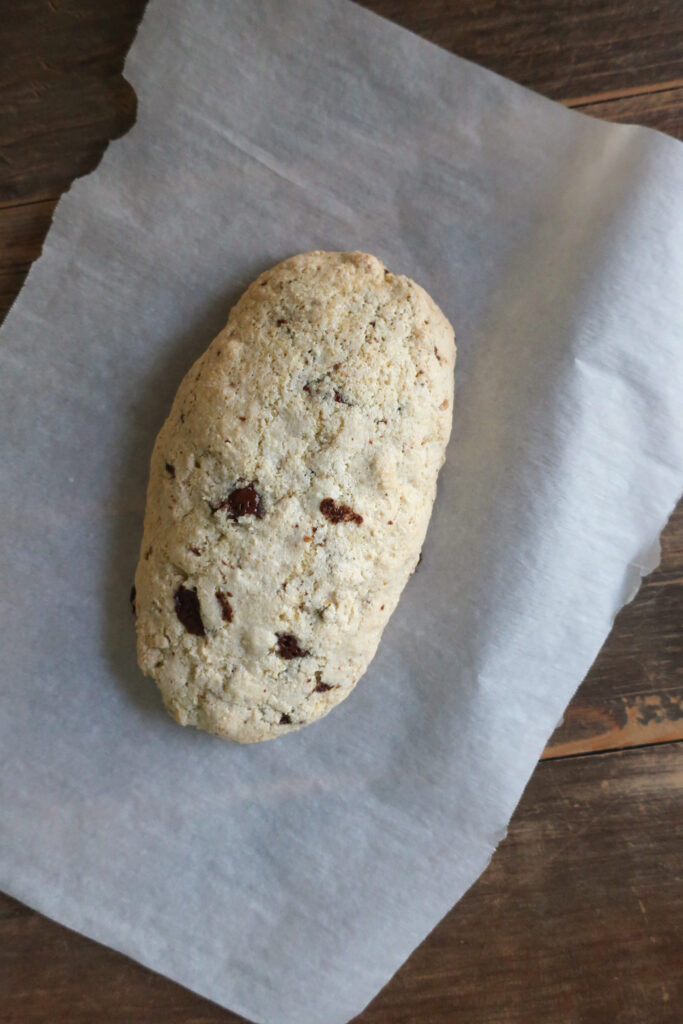 Pistachio and dark chocolate biscotti baked into a log for first bake