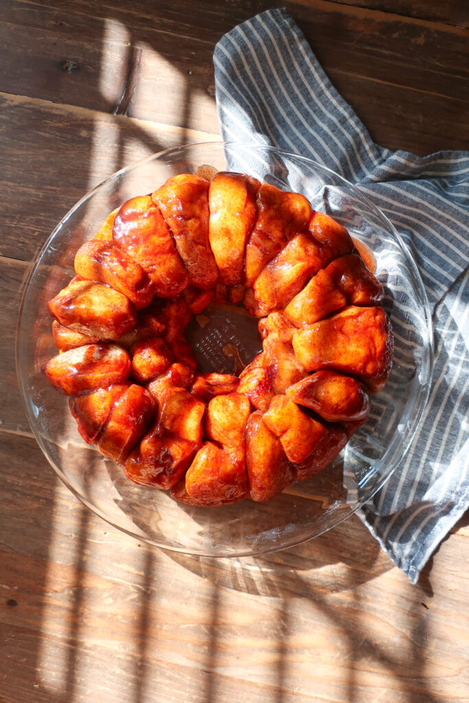 bubble bread in a pie dish, sitting on a striped blue towel