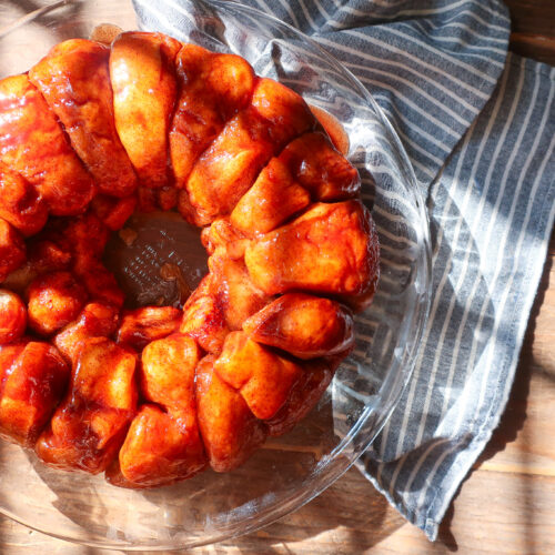 bubble bread in a pie dish, sitting on a striped blue towel