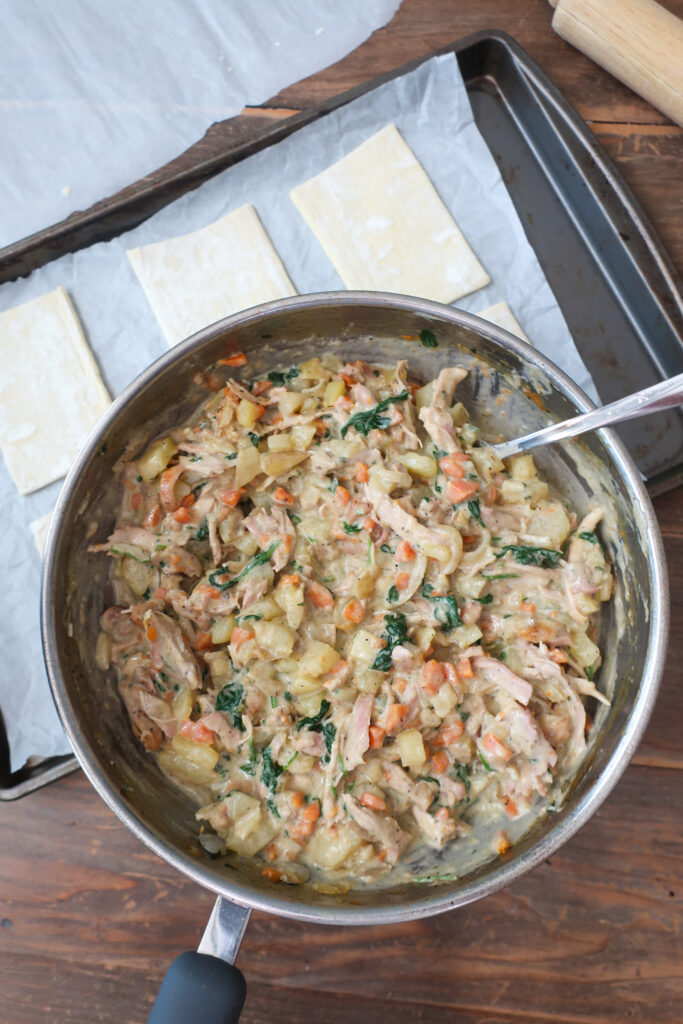 cooked filling for chicken hand pies with cut rectangles of puff pastry