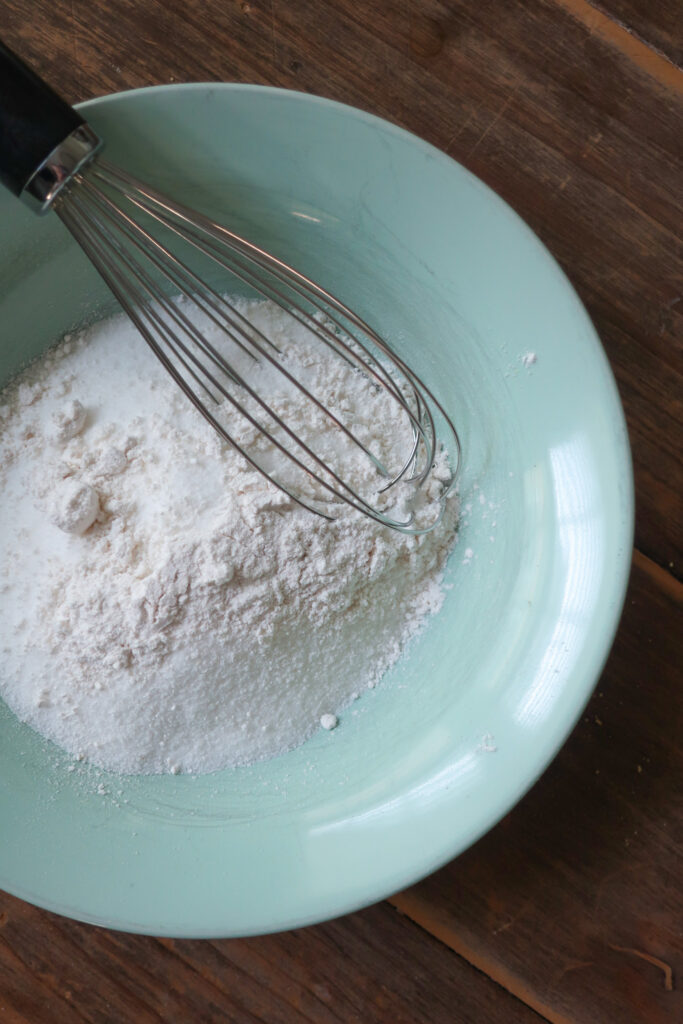 sugar and flour in a bowl with a whisk