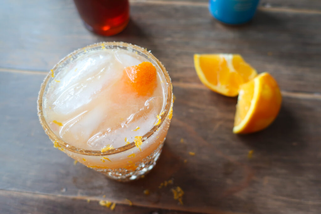 winter citrus spirtz mocktail; orange juice, ginger, grapefruit juice drink with salt and zest rim