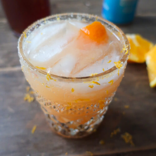 winter citrus spirtz mocktail; orange juice, ginger, grapefruit juice drink with salt and zest rim