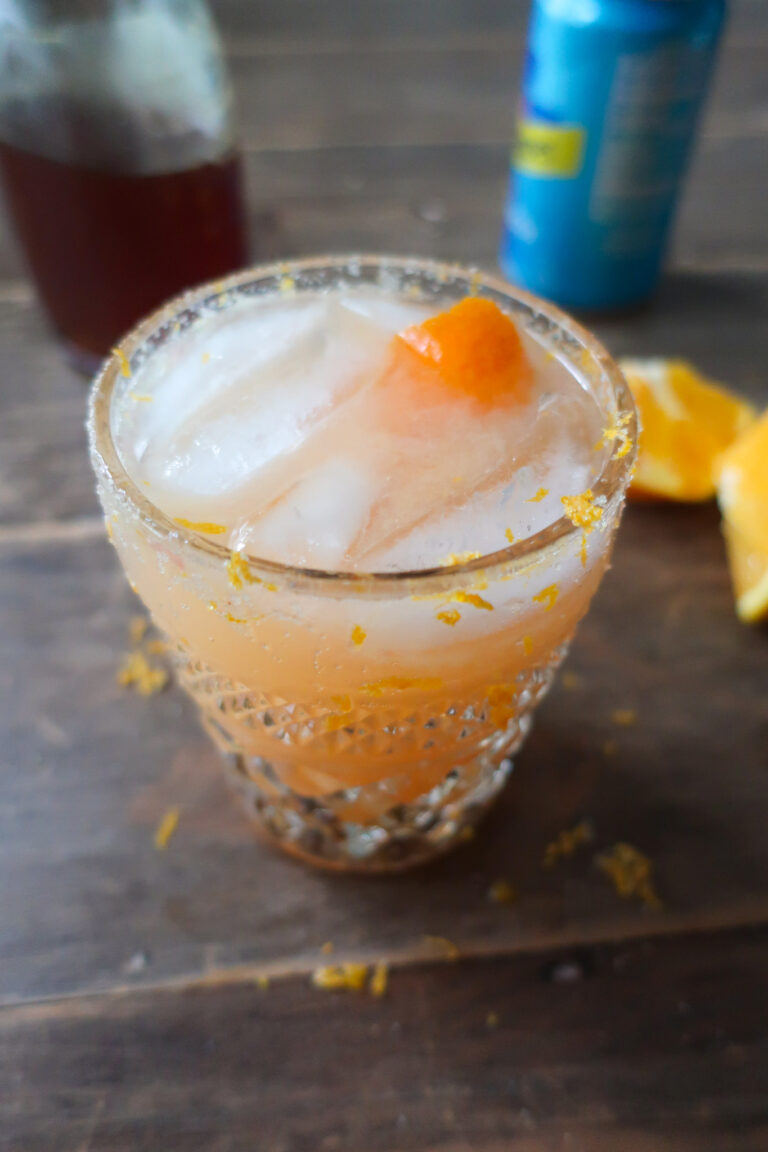 winter citrus spirtz mocktail; orange juice, ginger, grapefruit juice drink with salt and zest rim