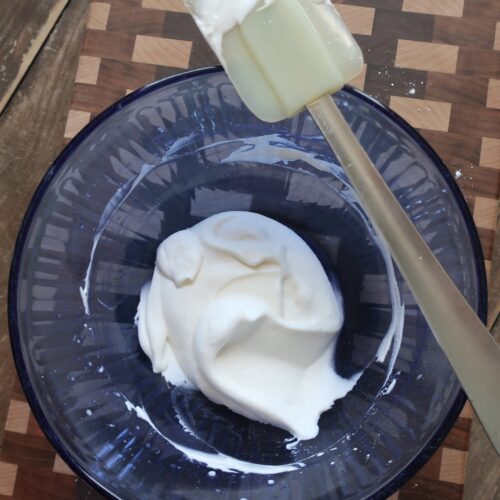 whipped cream; sweetened vanilla cream; chantilly cream; whipped cream in blue bowl with spatula