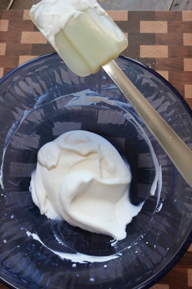 whipped cream; sweetened vanilla cream; chantilly cream; whipped cream in blue bowl with spatula