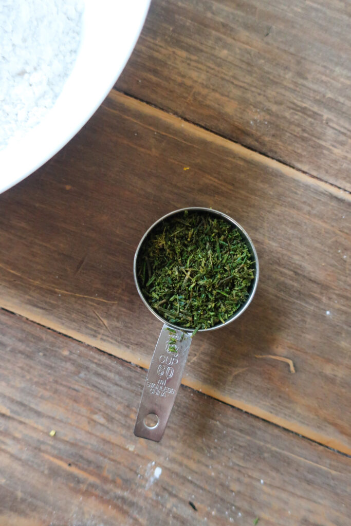 chopped rosemary in measuring cup; fresh rosemary; baking with rosemary; rosemary for lemon rosemary loaf cake