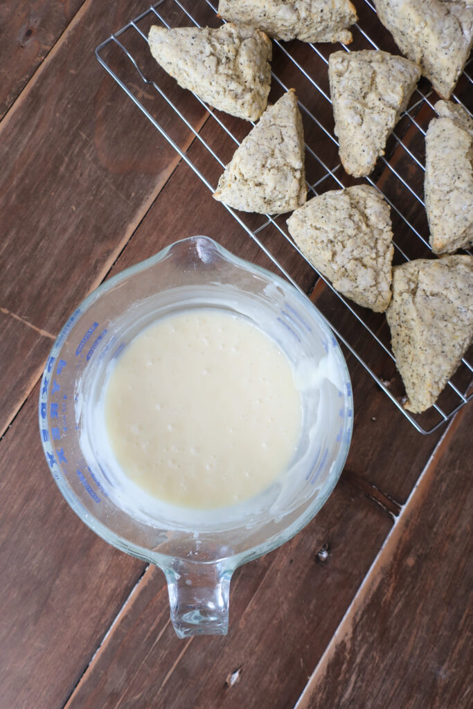 unglazed scones next to white chocolate lemon glaze; baking ingredients for scones; earl grey scones; lemon scones; sweet breakfast brunch recipe earl grey lemon scones with white chocolate lemon glaze