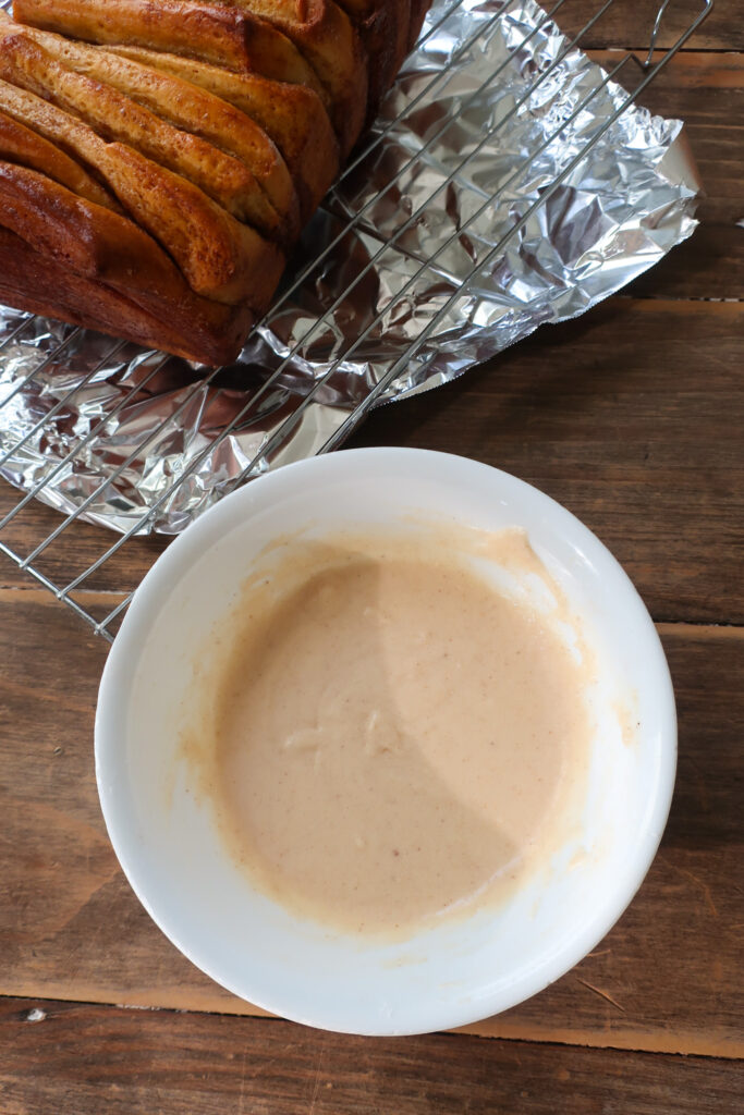 cinnamon sugar sweet potato pull-apart bread next to brown butter vanilla glaze