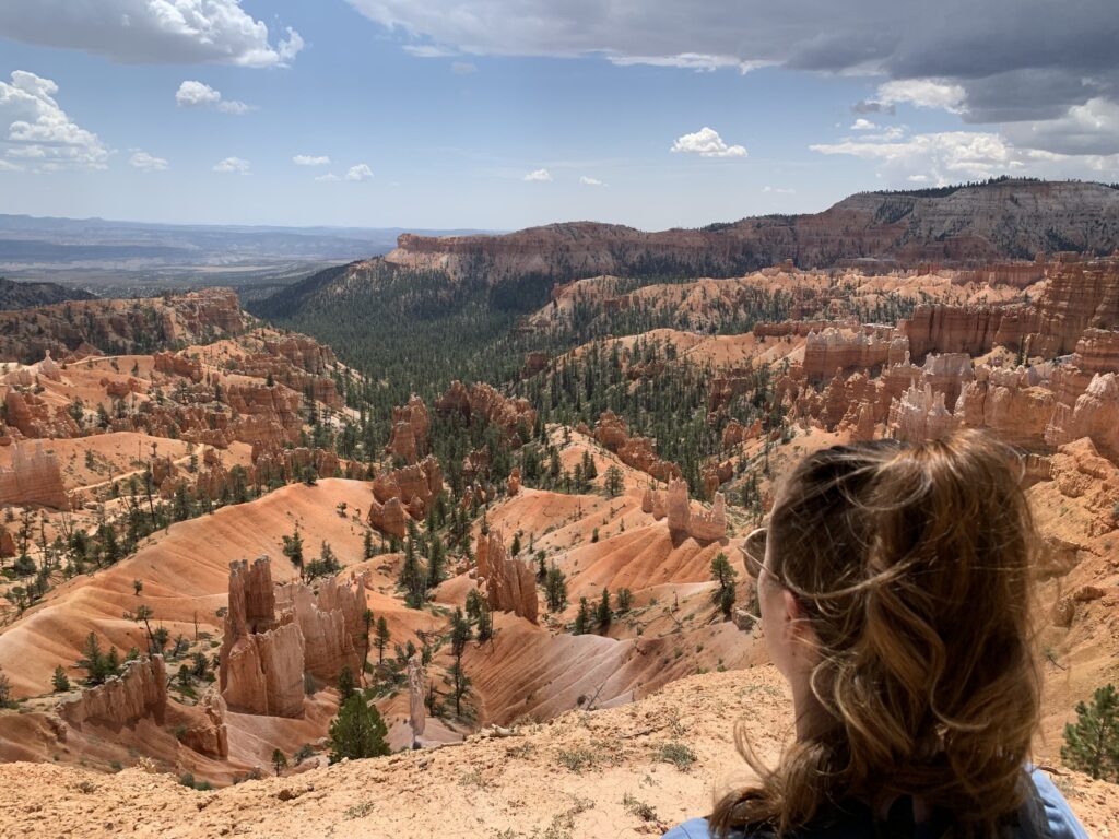 woman looking out over bryce national park, utah, usa; mother daughter trip; road trip south west; south west usa; utah travel itinerary; road trip tips; female travel; united states national park trip