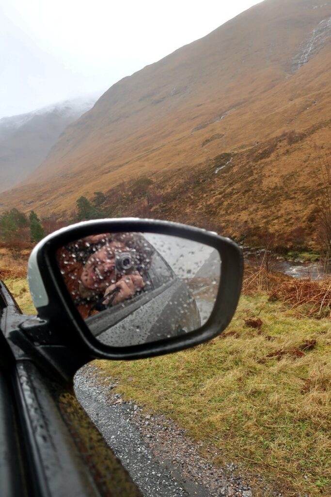 woman in car in glencoe, scotland, uk, europe; solo travel; solo female travel; roadtrip scotland; roadtrip europe; scotland itinerary