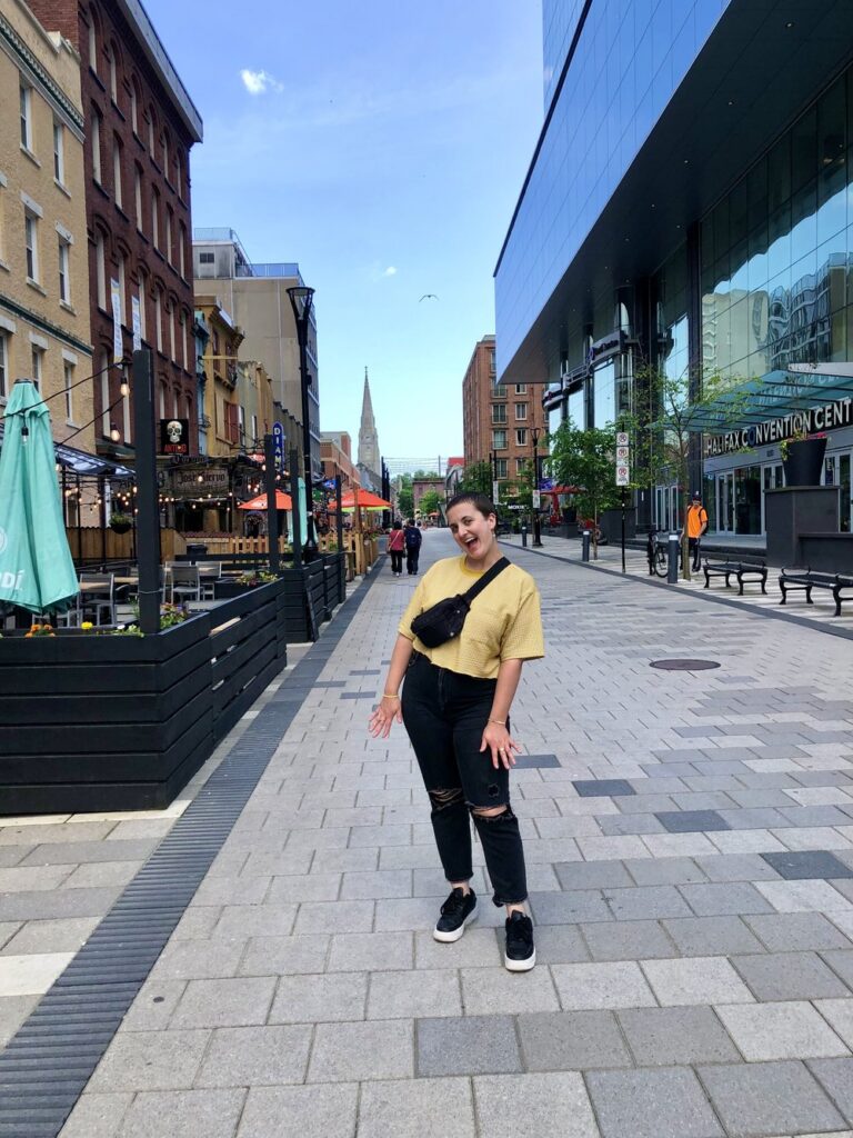 woman happy in yellow shirt in halifax, nova scotia, canada, north america; solo travel; solo female travel; roadtrip canada