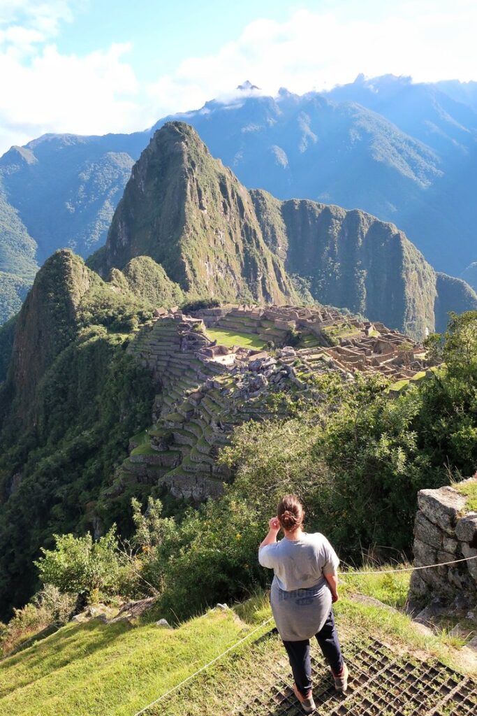 woman hiker looking out at machu picchu in peru, south america; solo female travel; solo backpacking; backpacking south america; backpacking tips; peru itinerary;