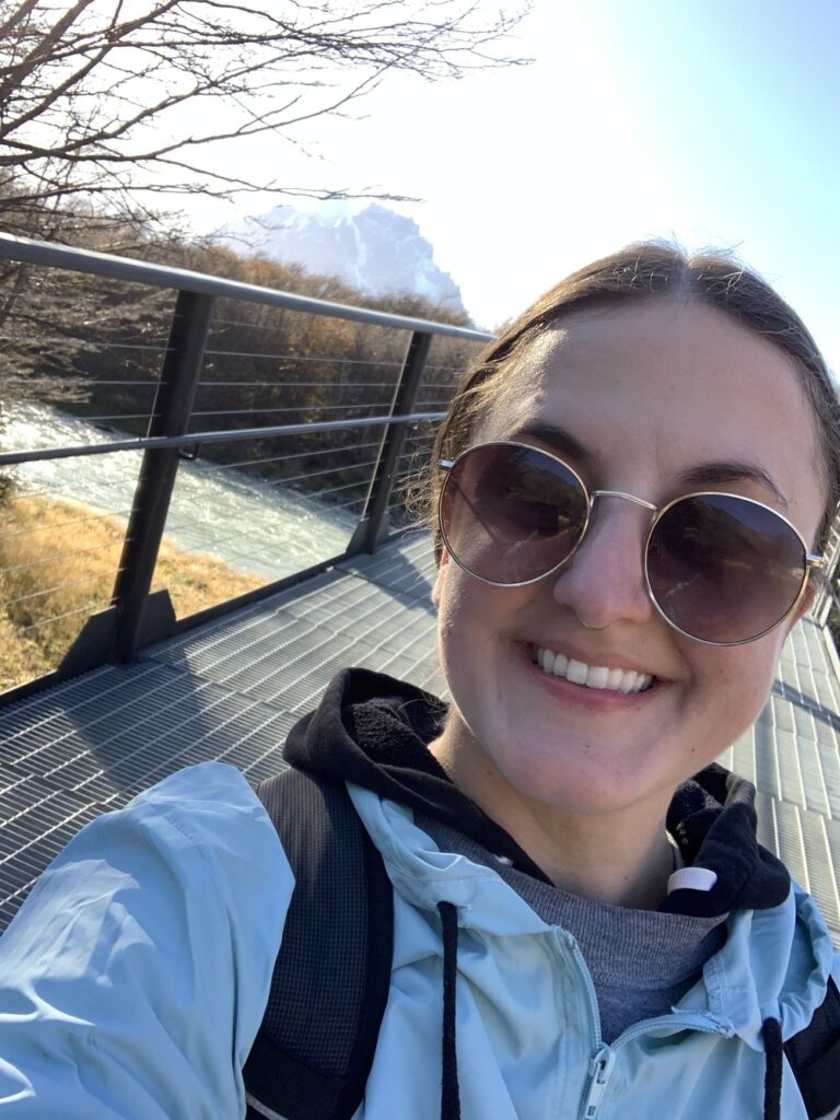 woman walking on bridge in torres del paine national park chile south america; solo female travel; solo backpacking; backpacking south america; backpacking tips; chile itinerary;