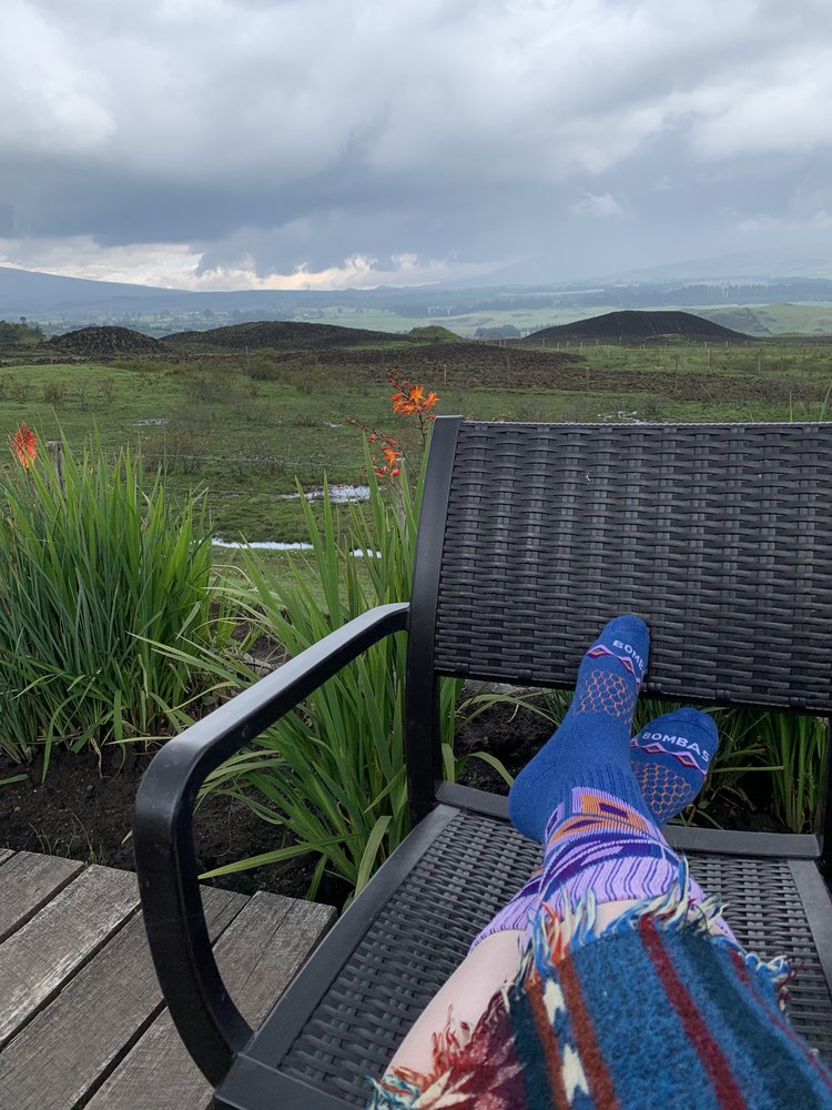 woman relaxing in cotopaxi ecuador, south america; solo female travel; solo backpacking; backpacking south america; backpacking tips; ecuador itinerary;