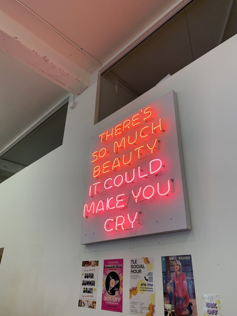 there's so much beauty it could make you cry sign hanging in boutique in portland, oregon; motivational quotes; motivational sign; positive sign; positive affirmation