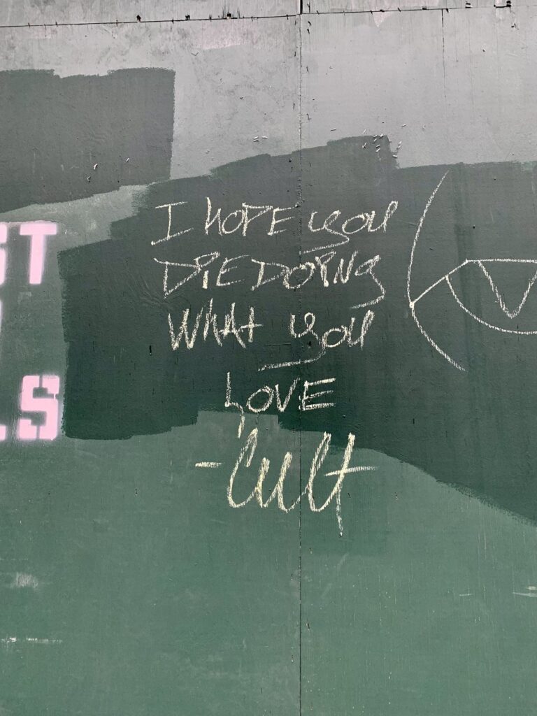 I hope you die doing what you love written on construction site in london, england; motivational quotes; motivational sign; positive sign; positive affirmation