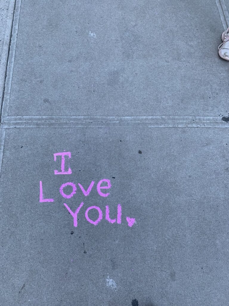 i love you written on a sidewalk in new york city; motivational quotes; motivational sign; positive sign; positive affirmation