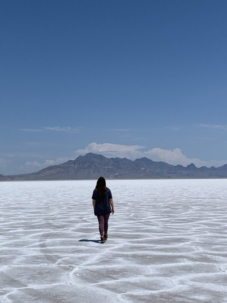 woman walking along on salt flats in utah, usa; mother daughter trip; road trip south west; south west usa; utah travel itinerary; road trip tips; female travel; united states national park trip