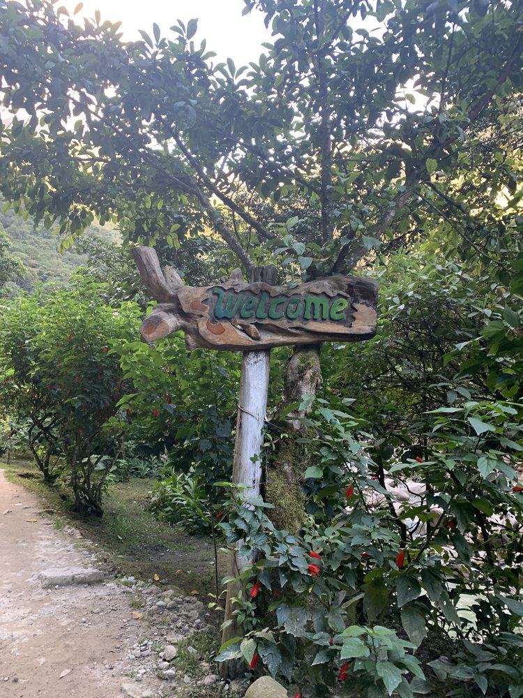 welcome sign on hike to aquas caliente; hydroelectrica hike; water river view in aguas caliente near machu picchu; solo female travel; solo backpacking; backpacking south america; backpacking tips; peru itinerary;