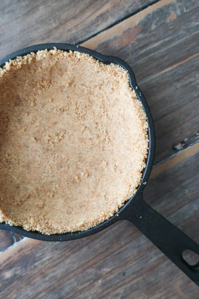 mini cast iron skillet, baked mini graham cracker crust, mini single-serve key lime cheesecake with whipped cream topping