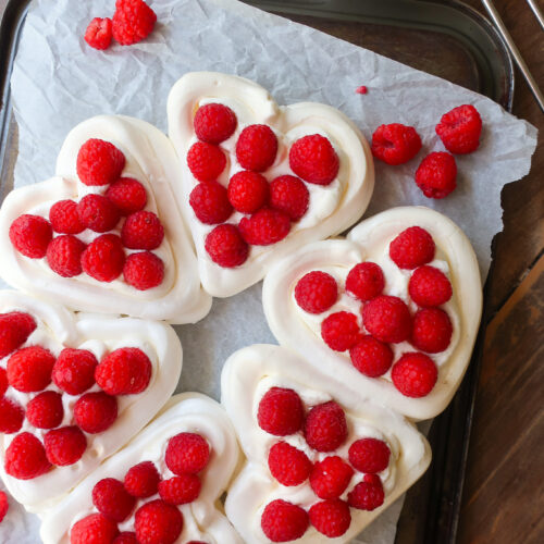 pavlova hearts wreath with french meringue, piped into heart baskets and filled with fresh whipped cream and fresh raspberries