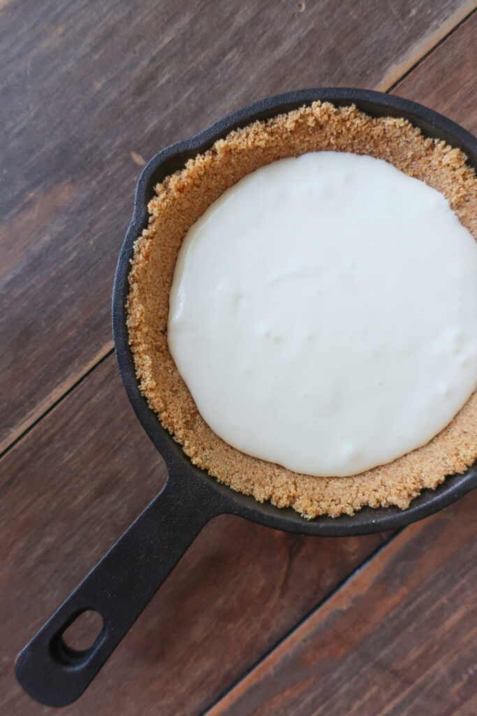 ingredients for mini single-serve key lime cheesecake with whipped cream topping in mini cast iron skillet