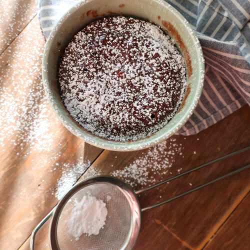 moist chocolate mug cake dusted with powdered sugar