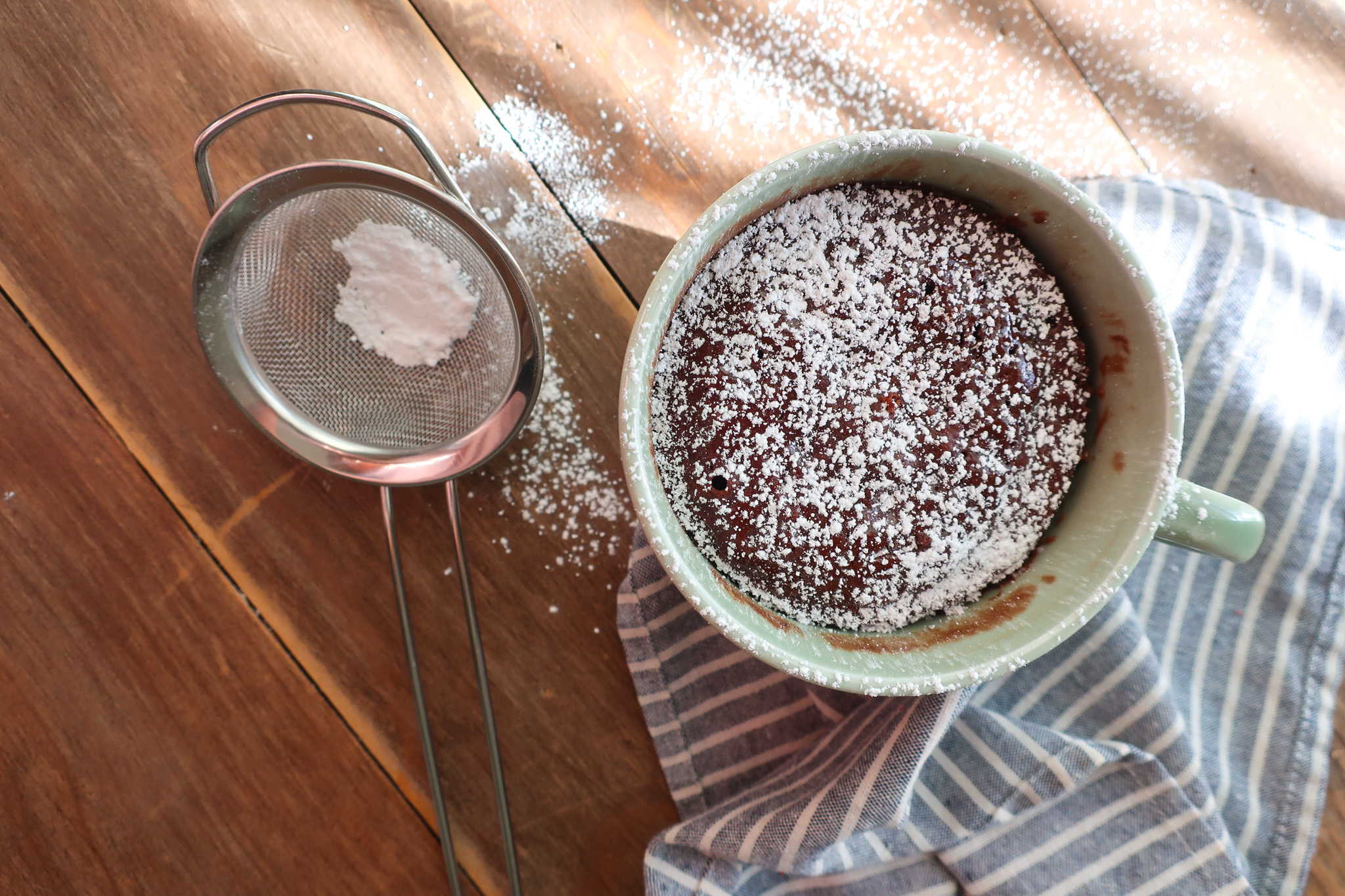 moist chocolate mug cake dusted with powdered sugar