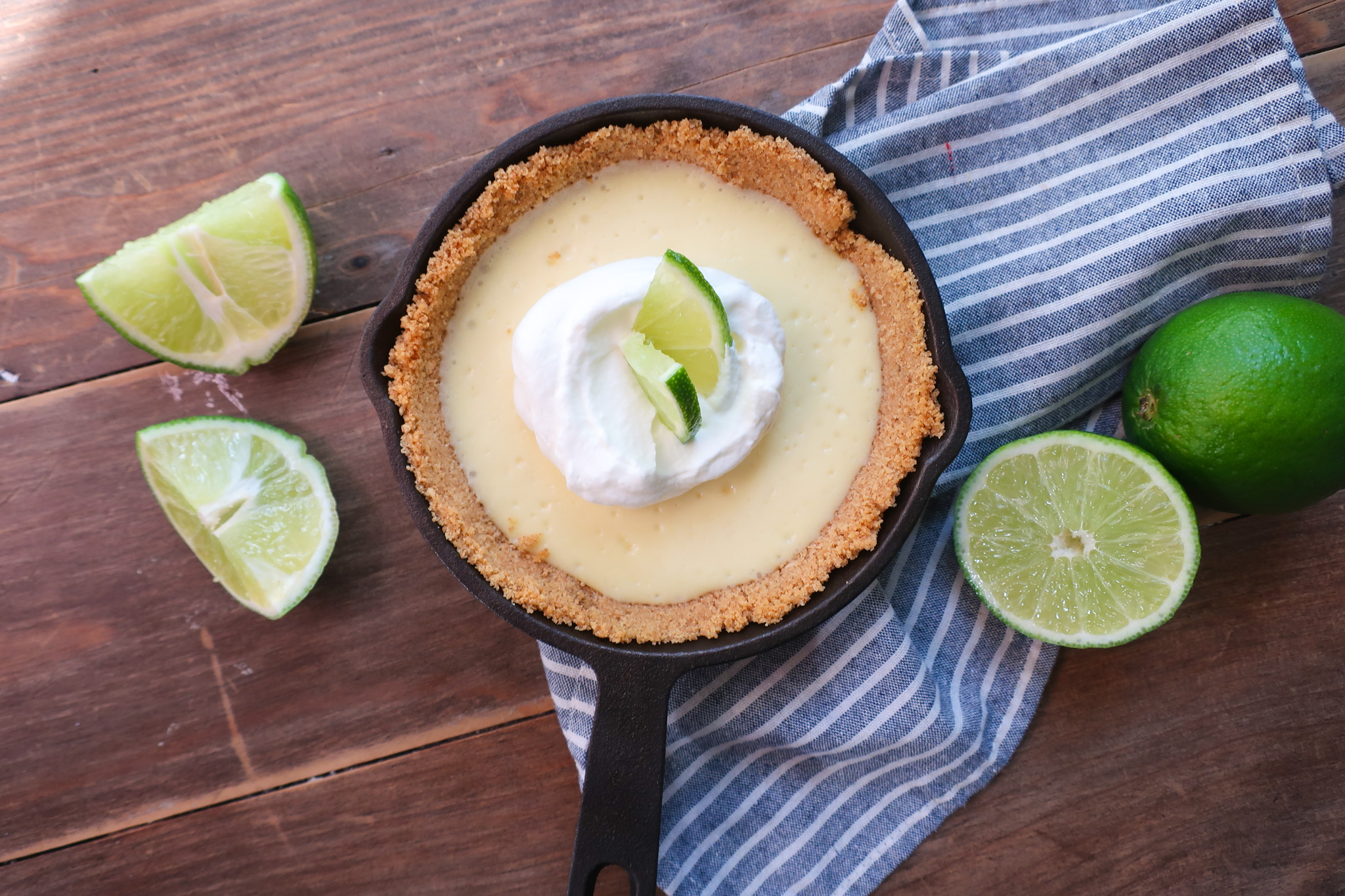 mini single-serve key lime cheesecake with whipped cream topping in mini cast iron skillet, individual cheesecake