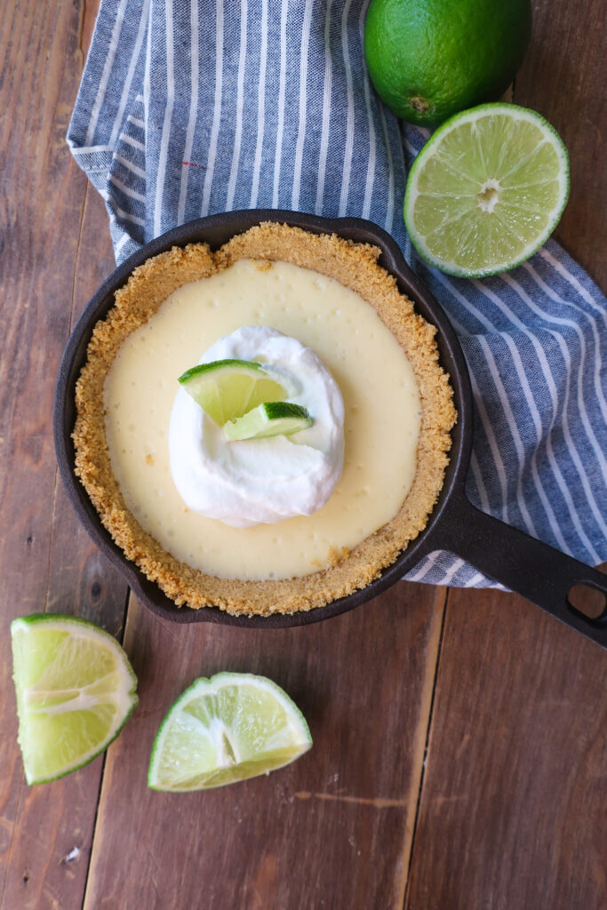 mini single-serve key lime cheesecake with whipped cream topping in mini cast iron skillet, individual cheesecake