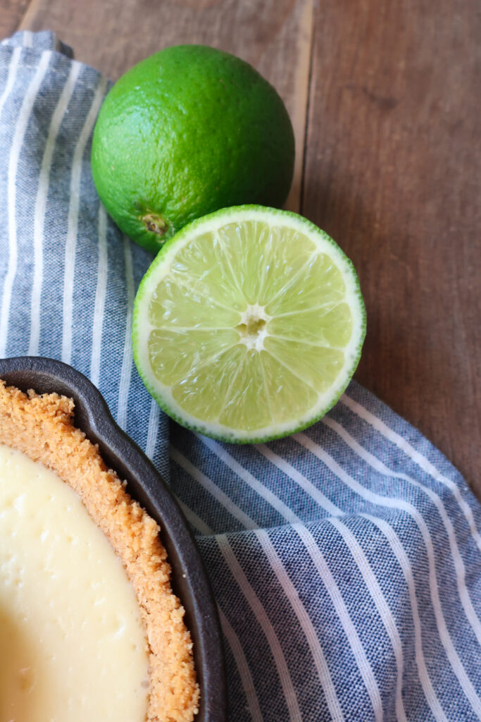 mini single-serve key lime cheesecake with whipped cream topping in mini cast iron skillet, individual cheesecake