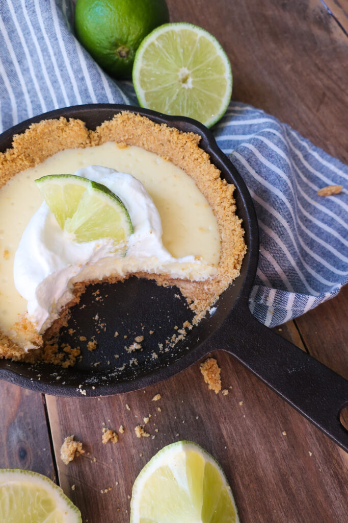 mini single-serve key lime cheesecake with whipped cream topping in mini cast iron skillet, individual cheesecake