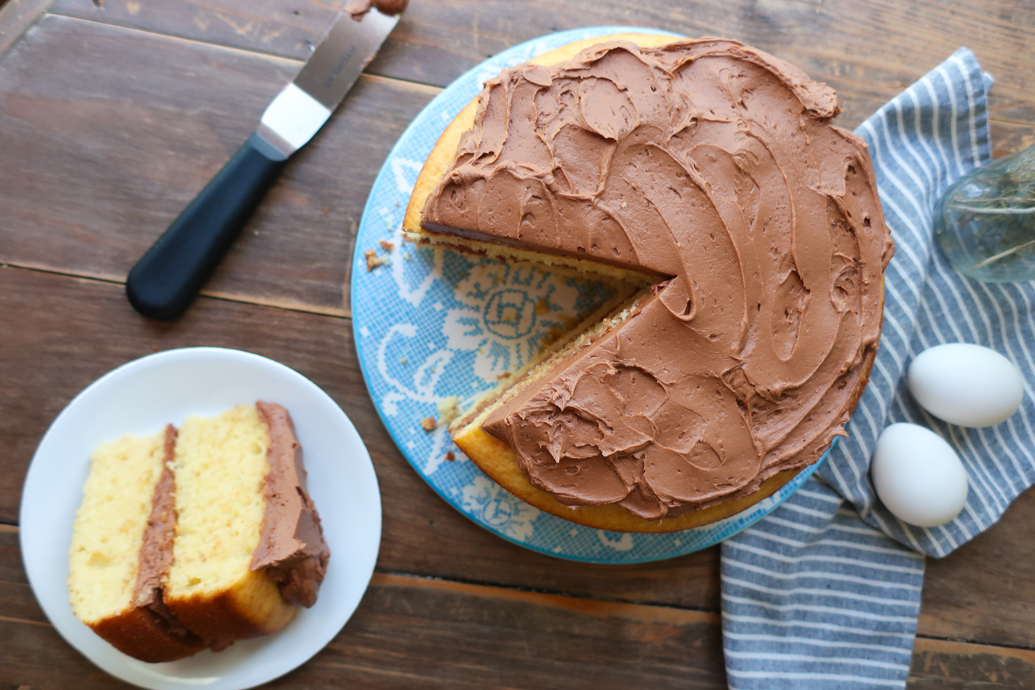 yellow tiered cake with chocolate buttercream frosting