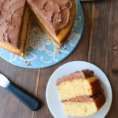 yellow tiered cake with chocolate buttercream frosting