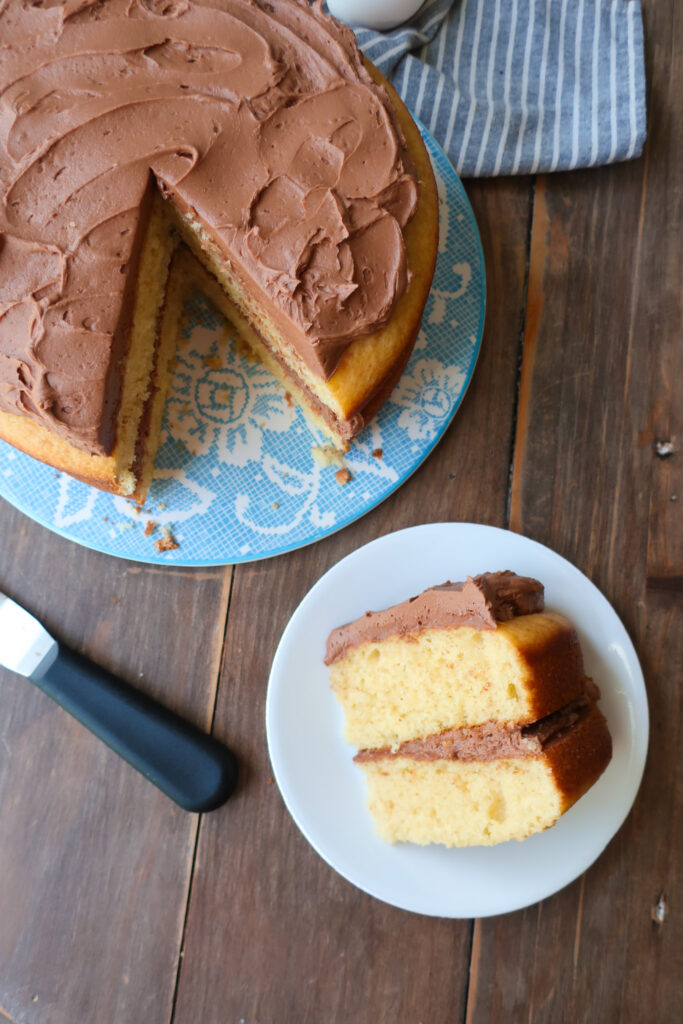 yellow tiered cake with chocolate buttercream frosting