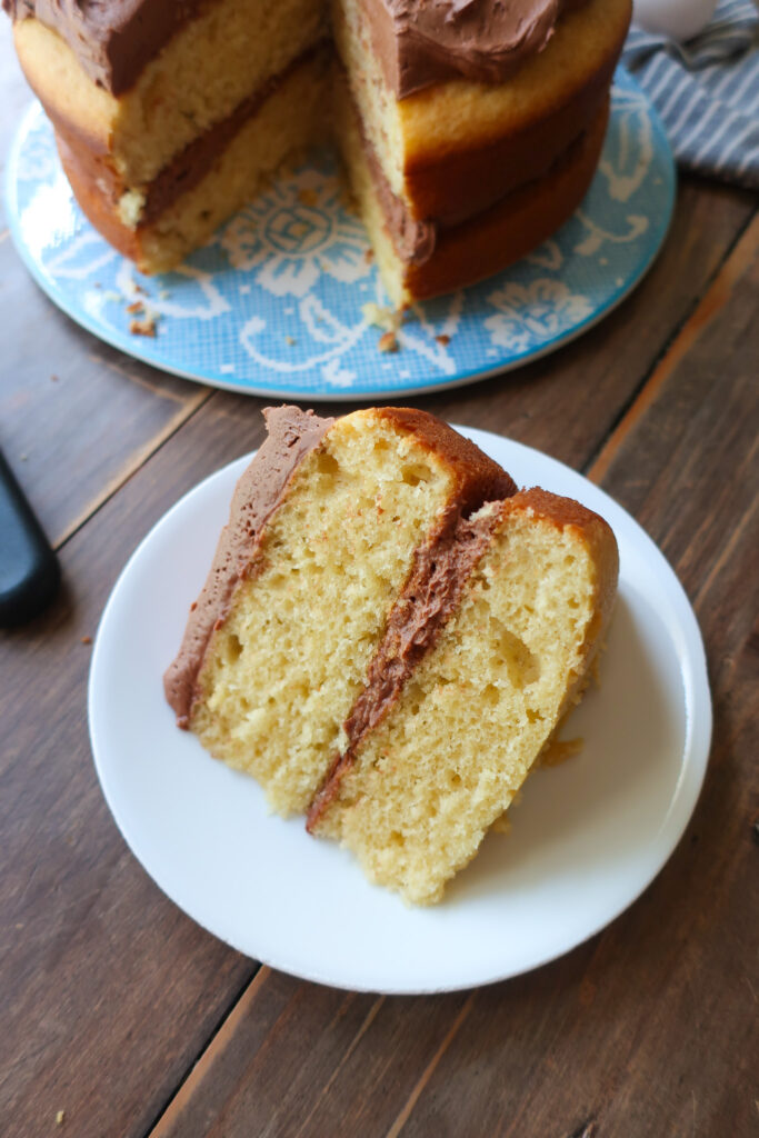 yellow tiered cake with chocolate buttercream frosting