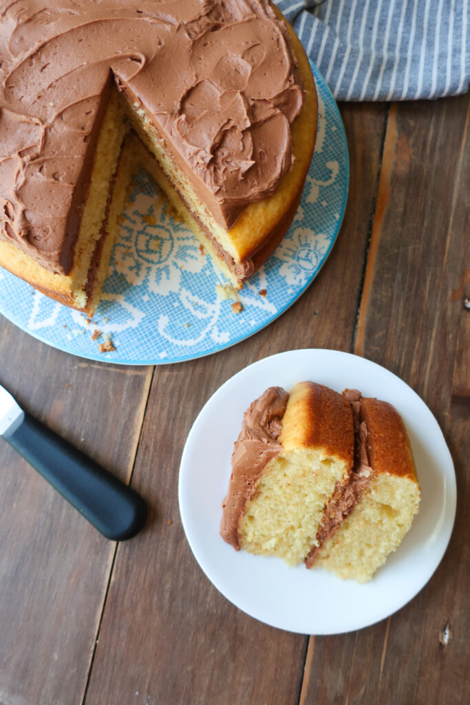 yellow tiered cake with chocolate buttercream frosting