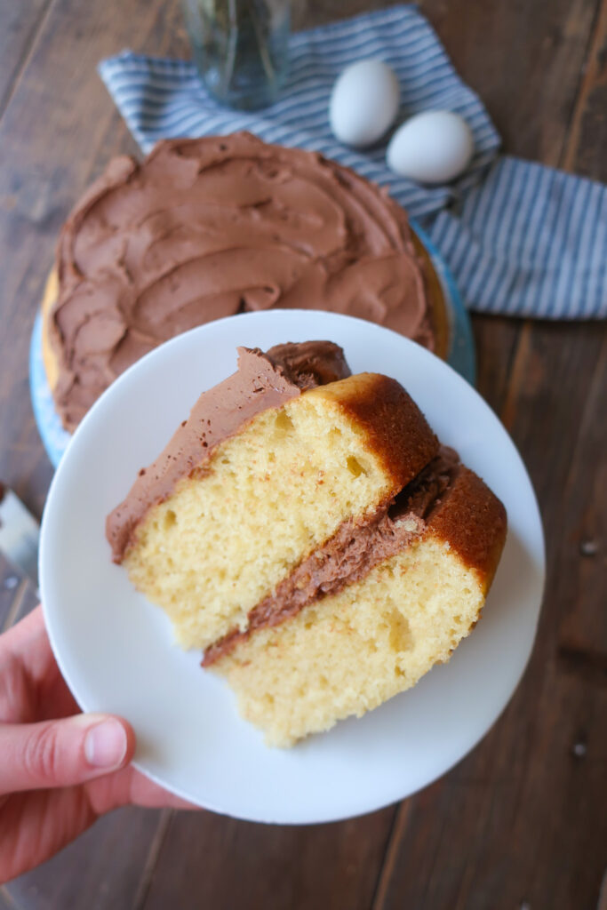 yellow tiered cake with chocolate buttercream frosting