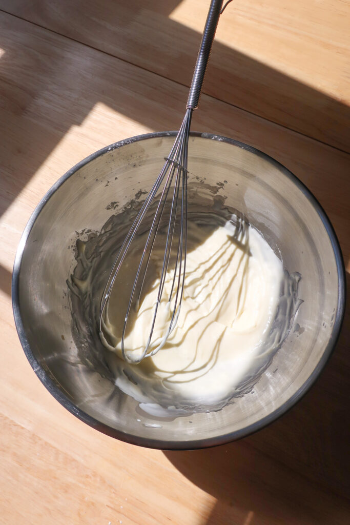 cream cheese glaze in metal bowl