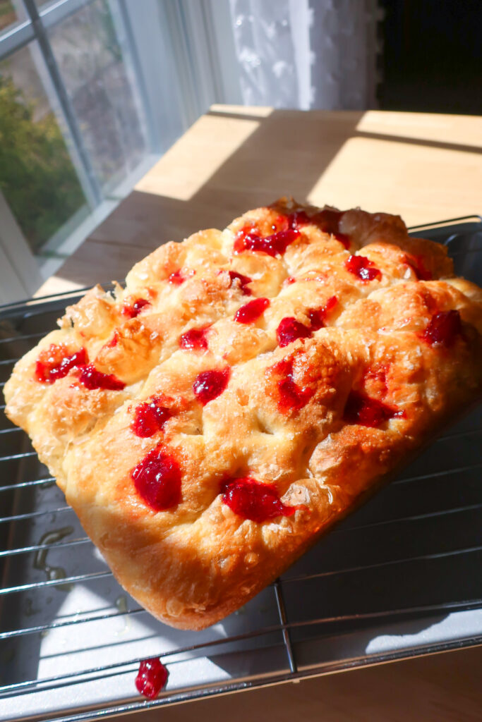 holes poked into focaccia filled with jam