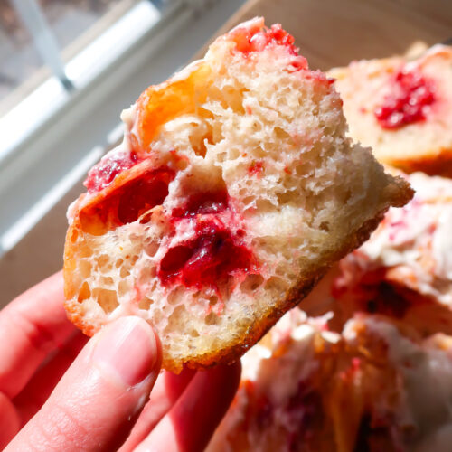 strawberry jam filling focaccia holes covered in cream cheese glaze