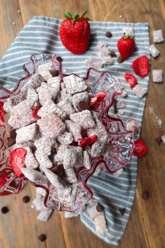 chocolate strawberry puppy chow on blue and white napkin