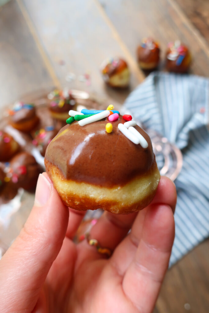 close up chocolate glazed donut hole