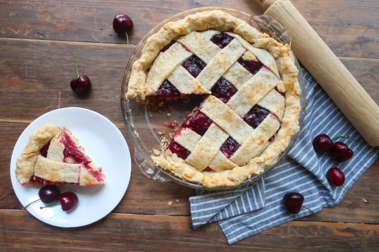 sliced cherry pie cake with lattice crust