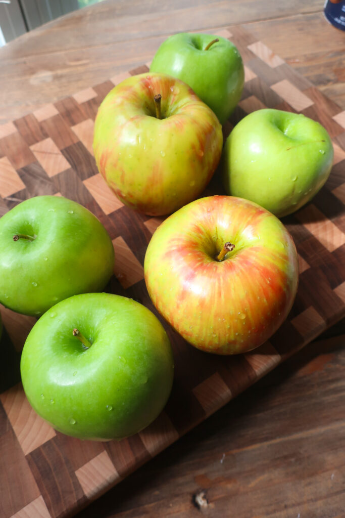 apples on a wooden cutting board
