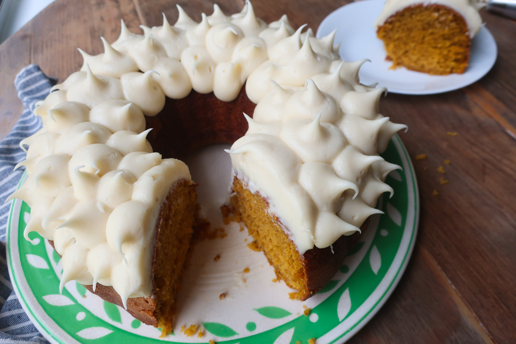 sliced soft pumpkin cake with cream cheese frosting
