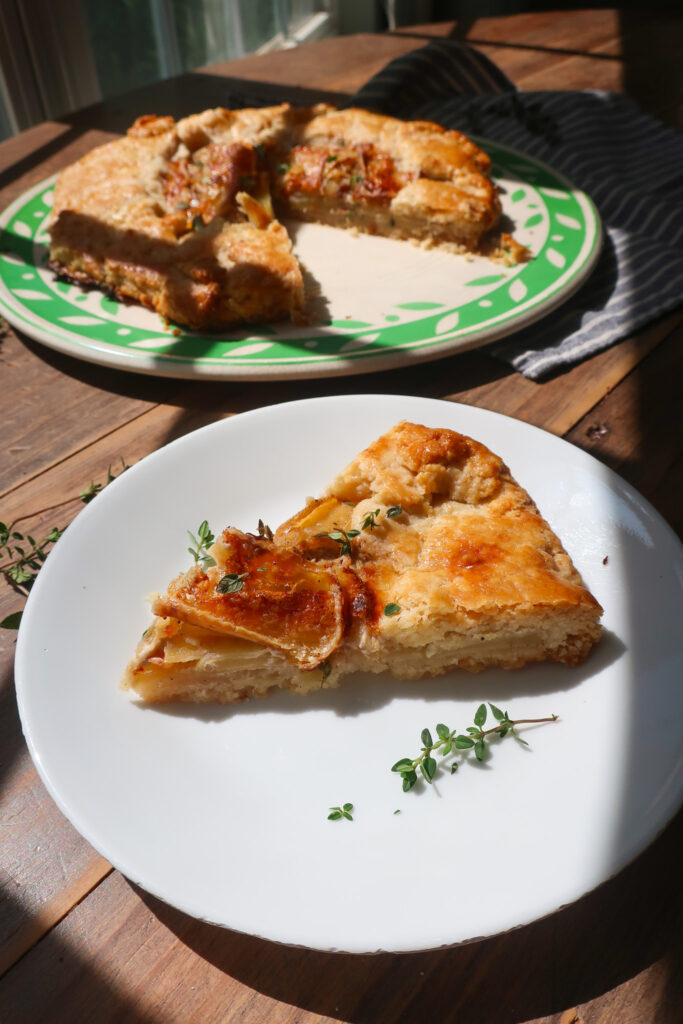 slice of tartiflette galette on white plate