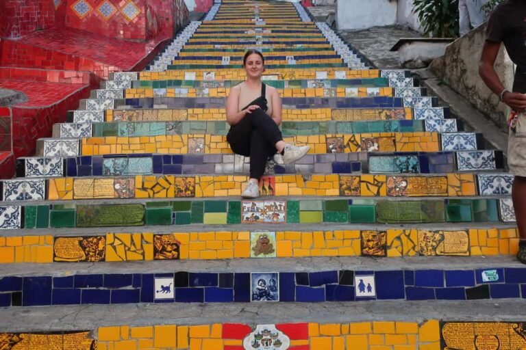 woman solo travel in Rio de Janeiro sitting on Selarón Staircase