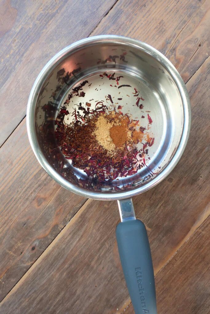 ingredients in pot for spiced rooibos hibiscus tea